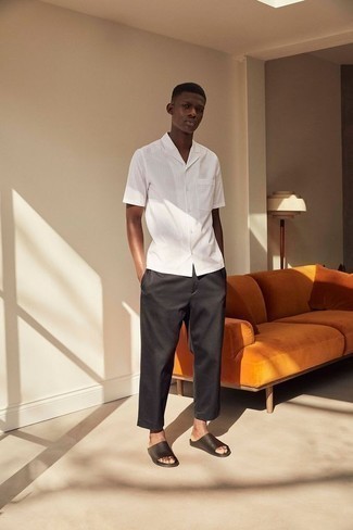 Black Leather Sandals Outfits For Men: Rock a white vertical striped short sleeve shirt with black chinos to feel instantly confident in yourself and look casually dapper. For something more on the daring side to complete this ensemble, add a pair of black leather sandals to the equation.