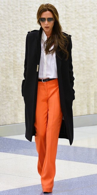 Victoria Beckham wearing Black Leather Belt, Orange Wide Leg Pants, White Dress Shirt, Black Coat