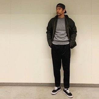 Black Windbreaker Outfits For Men: Inject variety into your current off-duty collection with a black windbreaker and black chinos. Let your sartorial savvy truly shine by complementing your outfit with a pair of black and white canvas low top sneakers.