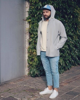 Grey Windbreaker Outfits For Men: Team a grey windbreaker with light blue jeans for a knockout outfit. A pair of white canvas low top sneakers will be a stylish companion for your look.