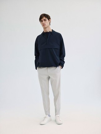 Navy Windbreaker Outfits For Men: A navy windbreaker and grey chinos are a nice pairing worth integrating into your day-to-day off-duty rotation. If you're on the fence about how to round off, complete your outfit with a pair of white canvas low top sneakers.