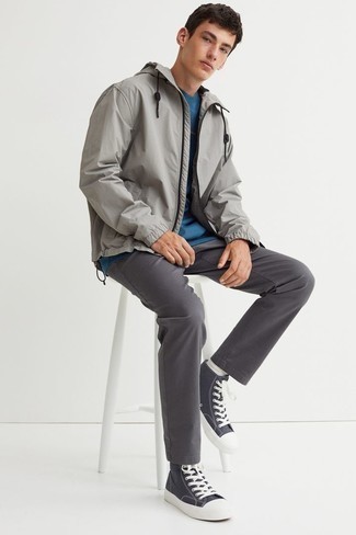 Grey Windbreaker Outfits For Men: This combination of a grey windbreaker and charcoal chinos will be a good demonstration of your skills in men's fashion even on lazy days. To give your overall ensemble a more relaxed vibe, complete your ensemble with a pair of charcoal canvas high top sneakers.