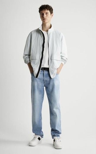 Men's Grey Windbreaker, White Crew-neck T-shirt, Light Blue Jeans, White and Black Leather Low Top Sneakers