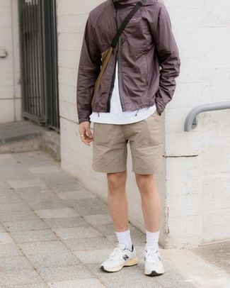 Beige Shorts Outfits For Men: This casual pairing of a brown windbreaker and beige shorts is extremely easy to pull together without a second thought, helping you look sharp and prepared for anything without spending a ton of time combing through your wardrobe. And if you want to effortlessly dress down this look with a pair of shoes, introduce white and black athletic shoes to this ensemble.