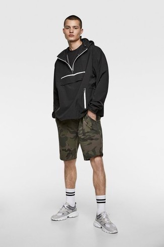 Black Windbreaker Outfits For Men: Dress in a black windbreaker and olive camouflage sports shorts for a cool and trendy getup. A pair of grey athletic shoes acts as the glue that brings this ensemble together.