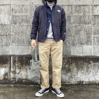 Men's Outfits 2021: This off-duty combo of a black windbreaker and a navy denim jacket is super easy to put together without a second thought, helping you look on-trend and prepared for anything without spending too much time digging through your wardrobe.