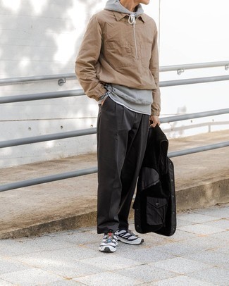 White and Black Athletic Shoes Outfits For Men: This relaxed combo of a tan windbreaker and charcoal chinos is a surefire option when you need to look stylish but have zero time to dress up. Introduce white and black athletic shoes to the mix to make the ensemble more fun.
