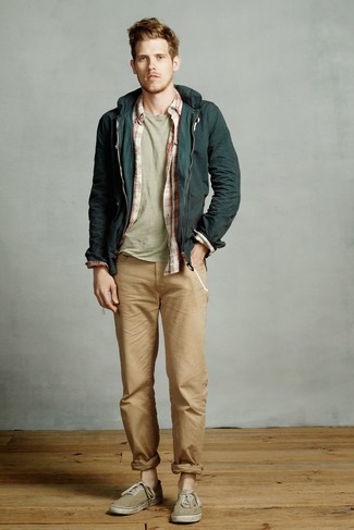 Dark Green Canvas Low Top Sneakers Outfits For Men: A dark green windbreaker and khaki jeans are the kind of a foolproof off-duty getup that you so terribly need when you have no extra time. Our favorite of a variety of ways to finish this look is a pair of dark green canvas low top sneakers.