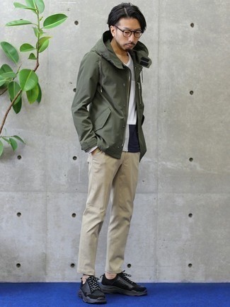 Men's Olive Windbreaker, White and Navy Long Sleeve T-Shirt, Beige Chinos, Black Athletic Shoes