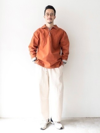 Men's Orange Windbreaker, Grey Long Sleeve T-Shirt, White Chinos, White and Black Athletic Shoes