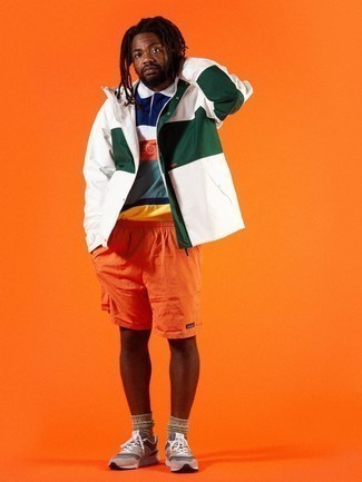 Yellow Shorts Outfits For Men: Go for a white and green windbreaker and yellow shorts to get an edgy and absolutely dapper ensemble. Go ahead and introduce tan athletic shoes to the equation for a fun feel.