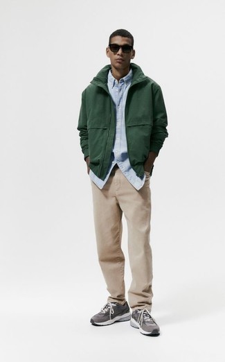 Dark Green Windbreaker Outfits For Men: This combo of a dark green windbreaker and khaki jeans delivers comfort and functionality and helps keep it low profile yet contemporary. On the fence about how to round off? Add grey athletic shoes to the equation for a more laid-back aesthetic.