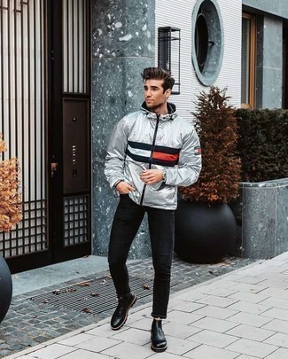 Silver Windbreaker Outfits For Men: This urban combo of a silver windbreaker and black skinny jeans is super easy to put together in next to no time, helping you look sharp and ready for anything without spending a ton of time combing through your wardrobe. Introduce black leather chelsea boots to your look to jazz things up.