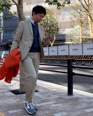 Blue Tie Outfits For Men: Team an orange windbreaker with a blue tie - this look will certainly make ladies go weak in the knees. A pair of navy and white athletic shoes immediately kicks up the fashion factor of this outfit.
