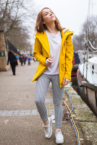 Anorak Outfits For Women: For an incredibly chic outfit without the need to sacrifice on comfort, we love this combination of an anorak and black and white gingham skinny pants. Finishing with white canvas low top sneakers is a guaranteed way to introduce a sense of playfulness to this look.