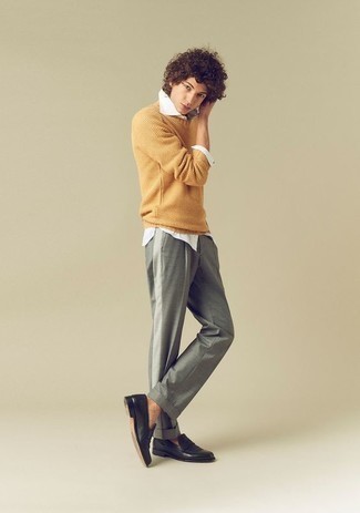 Mustard Crew-neck Sweater Outfits For Men: Look on-trend yet laid-back in a mustard crew-neck sweater and grey chinos. Black leather loafers are guaranteed to bring an added touch of style to your look.