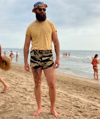 Yellow Crew-neck T-shirt Outfits For Men: Wearing something as basic as this contemporary combination of a yellow crew-neck t-shirt and black camouflage swim shorts will set you apart in a good way.
