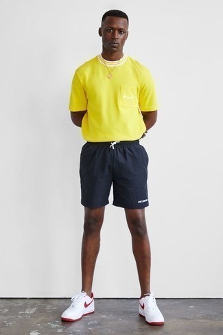 Navy Sports Shorts Outfits For Men: Putting together a yellow crew-neck t-shirt with navy sports shorts is a savvy pick for a casual look. A pair of white and red athletic shoes completes this look very nicely.