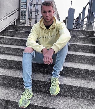 Mustard Athletic Shoes Outfits For Men: This casual combo of a yellow hoodie and light blue ripped skinny jeans can only be described as outrageously stylish. When in doubt as to the footwear, stick to a pair of mustard athletic shoes.