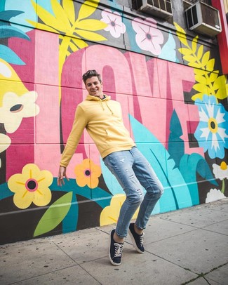 Mustard Hoodie Outfits For Men: This combination of a mustard hoodie and light blue ripped skinny jeans will prove your skills in men's fashion even on lazy days. For maximum fashion points, introduce a pair of navy canvas low top sneakers to this outfit.
