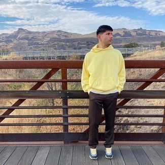 Mustard Hoodie Outfits For Men: A mustard hoodie and dark brown chinos will inject extra style into your current casual arsenal. Puzzled as to how to round off? Choose a pair of multi colored athletic shoes to spice things up.