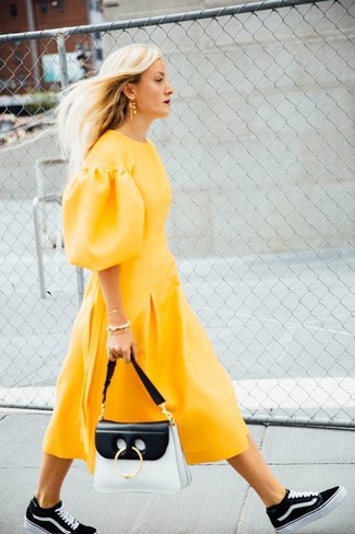 Women's Yellow Midi Dress, Black and White High Top Sneakers, White and Black Leather Satchel Bag, Gold Earrings