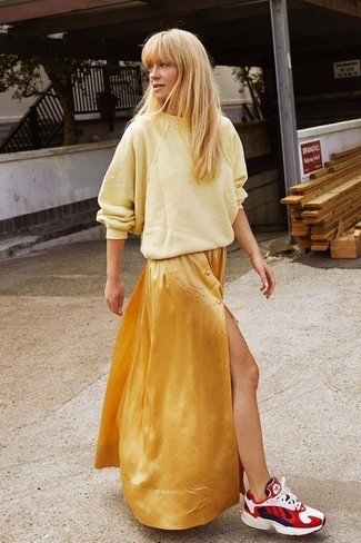 Yellow Oversized Sweater Outfits: This relaxed pairing of a yellow oversized sweater and a gold maxi dress is extremely easy to pull together without a second thought, helping you look chic and ready for anything without spending too much time rummaging through your wardrobe. Bump up the cool of your ensemble by sporting a pair of red athletic shoes.