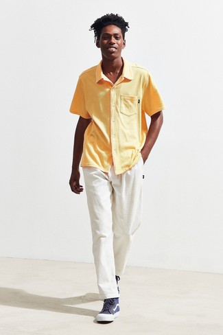 Navy High Top Sneakers Outfits For Men: This combo of a yellow short sleeve shirt and white corduroy jeans is hard proof that a straightforward casual ensemble doesn't have to be boring. Go the extra mile and change up your getup by wearing navy high top sneakers.