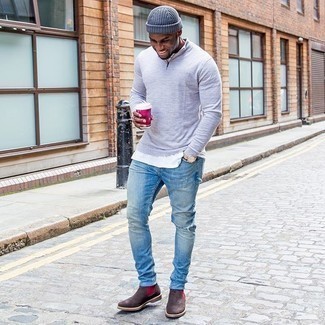 Charcoal Zip Neck Sweater Outfits For Men: Wear a charcoal zip neck sweater with light blue ripped jeans for a relaxed casual menswear style with an edgy spin. If you wish to immediately lift up this look with one single item, why not complete your outfit with a pair of dark brown suede chelsea boots?