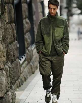 Dark Green Zip Sweater Outfits For Men: Extremely dapper, this off-duty pairing of a dark green zip sweater and olive chinos will provide you with a multitude of styling possibilities. Puzzled as to how to round off? Complement your look with a pair of olive athletic shoes for a more casual take.