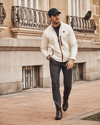 White Zip Sweater Outfits For Men: A white zip sweater and charcoal wool chinos are the perfect way to inject extra cool into your day-to-day routine. Balance out your getup with a smarter kind of footwear, such as these dark brown leather brogue boots.