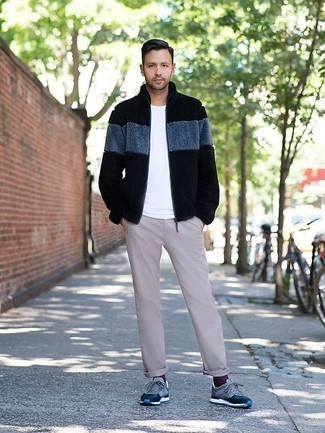 Black Fleece Zip Sweater Outfits For Men: This pairing of a black fleece zip sweater and beige chinos is simple, stylish and very easy to recreate. Play down the classiness of your ensemble by finishing off with blue athletic shoes.