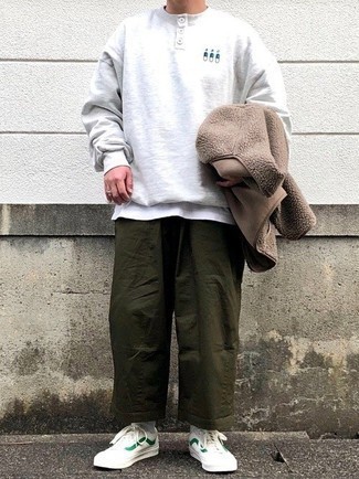 Brown Zip Sweater Outfits For Men: This combo of a brown zip sweater and olive chinos is definitive proof that a simple off-duty getup can still look truly sharp. Puzzled as to how to round off? Complement this ensemble with white and green canvas low top sneakers to change things up a bit.