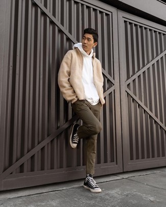 White Hoodie Outfits For Men: This combo of a white hoodie and olive chinos is simple, seriously stylish and extremely easy to replicate. Infuse a touch of stylish casualness into your look by slipping into black and white canvas high top sneakers.