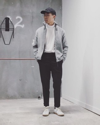 Black Baseball Cap Outfits For Men: Rock a grey fleece zip sweater with a black baseball cap for an easy-to-style outfit. Finishing off with a pair of white canvas low top sneakers is a surefire way to introduce some extra classiness to this outfit.