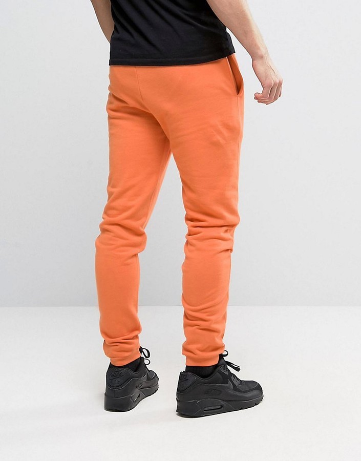 Asos Skinny Joggers With Gothic Text In Orange, $20, Asos