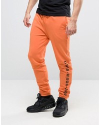 Asos Skinny Joggers With Gothic Text In Orange